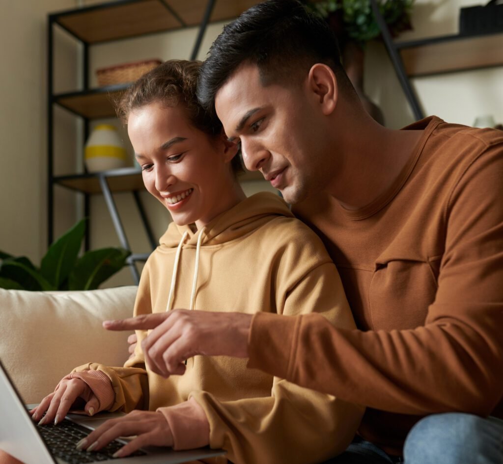 Couple reviewing home buying information together on a laptop at home.